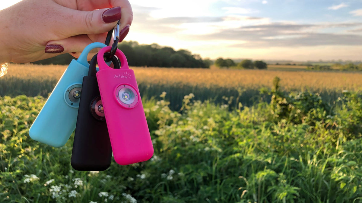 Ashley personal alarms clipped to keys outdoors at sunset